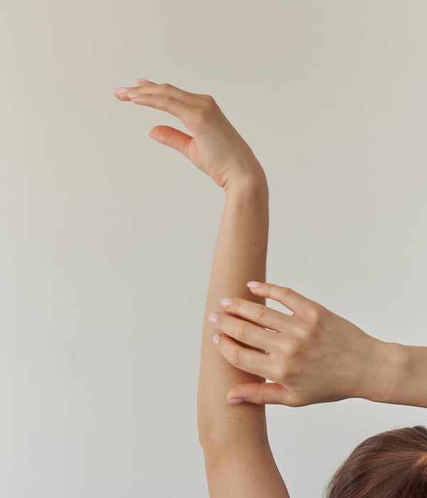 Woman in a graceful yoga pose with azure light accents.